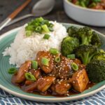 Plated bourbon chicken with rice and broccoli